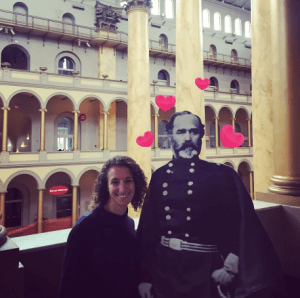 a man and a woman standing in front of a building