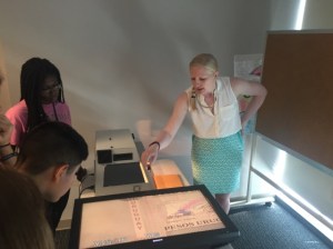 a group of people looking at a laptop