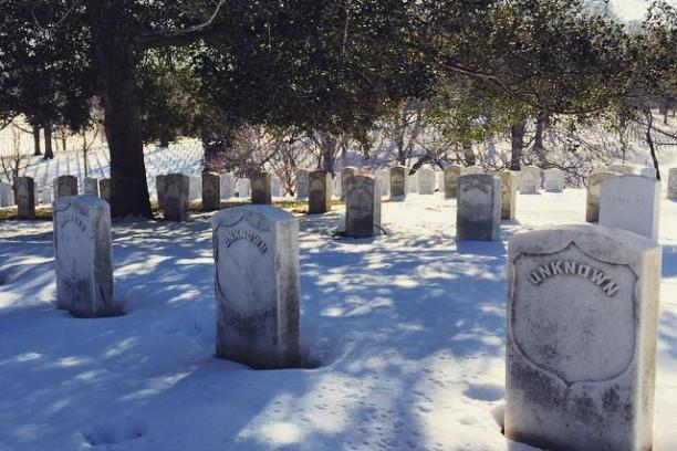 a sign on the side of a snow covered park