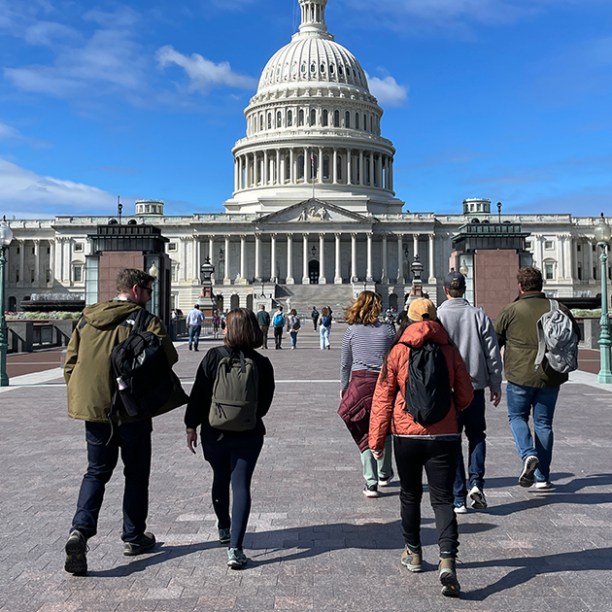 a group of people walking in front of a building