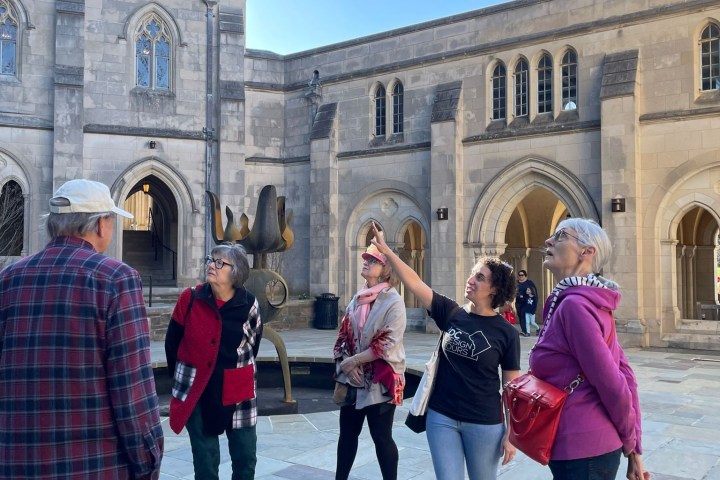 a group of people walking in front of a building