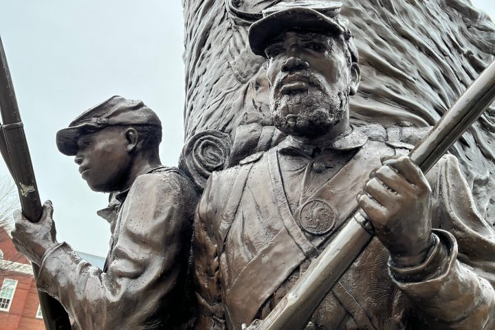a statue of a man holding a baseball bat