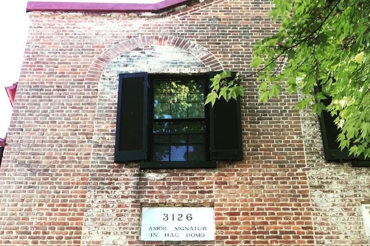 a sign in front of a brick building