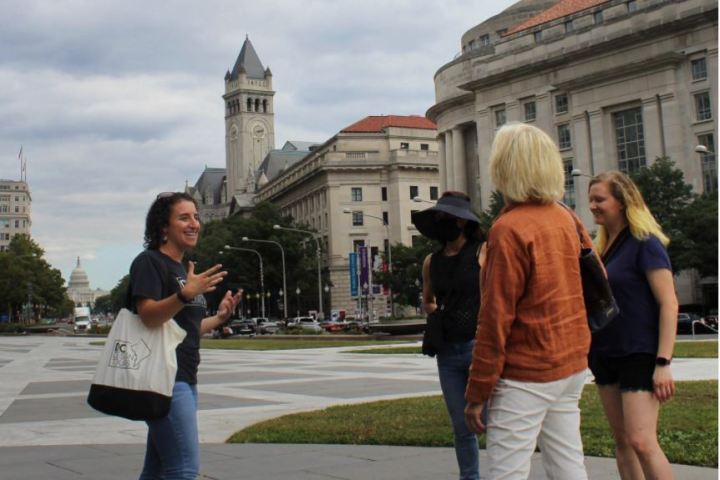 a group of people walking in front of a building
