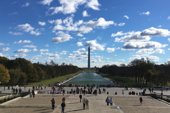 a group of people standing in a parking lot