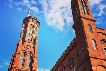 a large tall tower with a clock on the side of a building