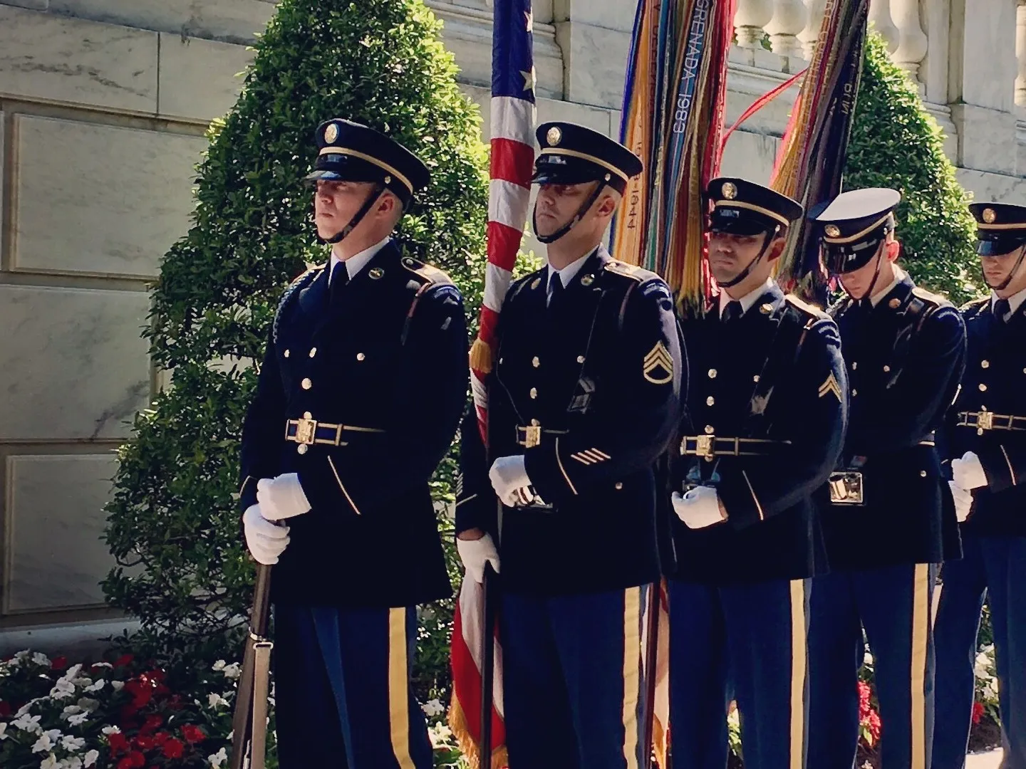 a group of people in uniform standing in front of a building