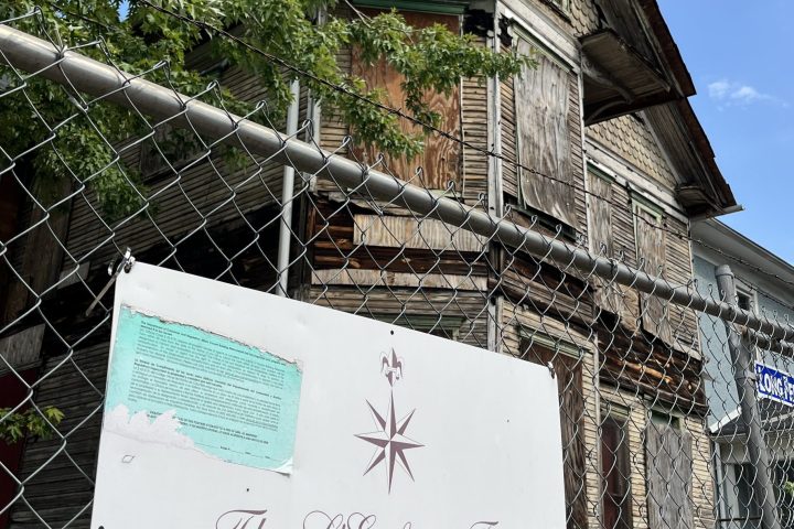 a sign in front of a brick building