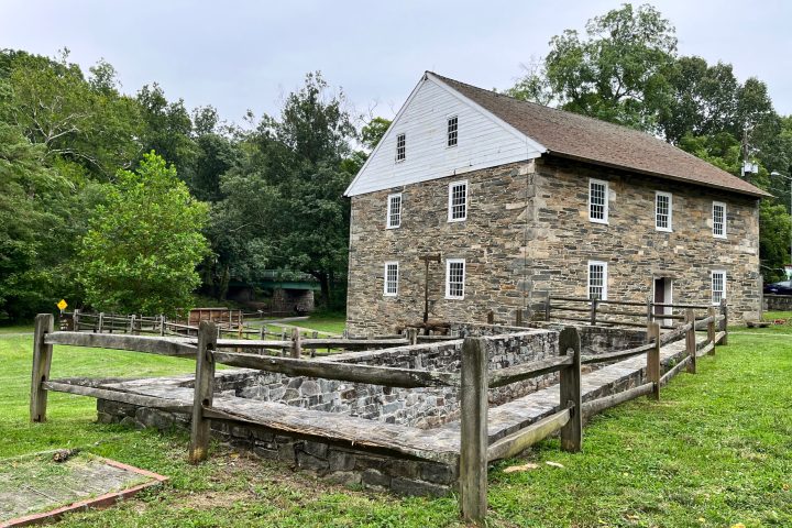 an old house with trees in the background